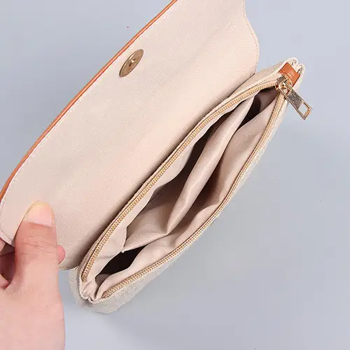 Close-up of sustainable natural linen texture and premium vegan leather trim on cosmetic bag
